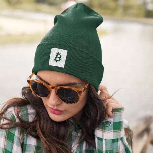 a woman wearing a bit swagg bitcoin square beanie in spruce green