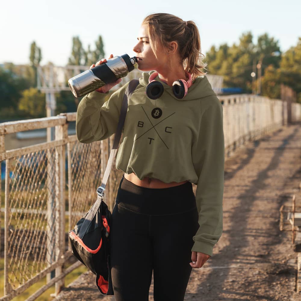 a womean wearing a bit swagg bitcoin x-mark cropped hoodie in military green