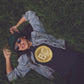 Girl laying on grass wearing a bit swagg 2009 bitcoin logo t-shirt in navy