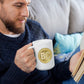 a man holding a bit swagg bitcoin mug in white