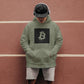  a cool man with headphones rocking a bit swagg bitcoin square logo hoodie in military green