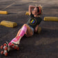 a girl in roller skates in a bit swagg stenciled pride t shirt in black