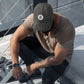 a man wearing a bit swagg solid bitcoin distressed cap in grey
