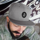 a guy wearing a bit swagg solid bitcoin snapback hat in silver